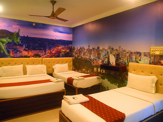 Spacious Family Room with one queen bed and two single beds at a hotel near Trichy railway station