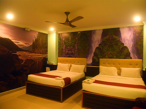 Spacious twin-bed room with tufted headboards and modern amenities, offering rooms near Chatram bus stand