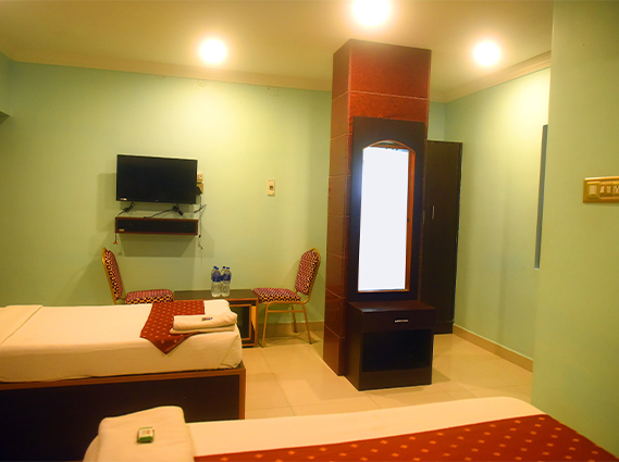 Spacious triple room with three comfortable beds, ideal for a budget stay for family in Trichy